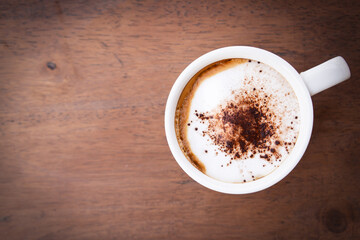 Hot coffee. Cappuccino on wooden table. Top view with copy space.