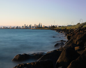 Sunset over the city of Melbourne with the ocean long exposure