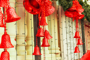 Large red Christmas bells with bows, lights, green branches of the Christmas tree close-up.New year 2021 and Christmas,new year mood, new year decorations