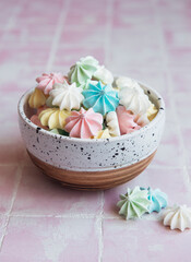 Small colorful meringues in the  ceramic bowl