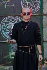 A man dressed as a priest. Halloween image. Вlack magic.
