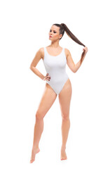 Fototapeta premium Young, fit and beautiful brunette woman in white swimsuit isolated on white background. Healthcare, diet, sport and fitness.