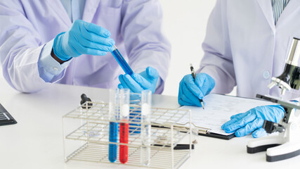 Fototapeta premium Team of Medical Research Scientists or researcher in lab coat testing their experimental in Modern laboratory.