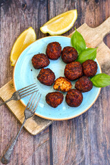 Home made deep fried   mini  fish and vegetables meatballs ,on  rustic background