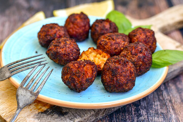 Home made deep fried   mini  fish and vegetables meatballs ,on  rustic background