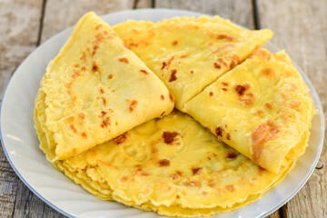 Bakery. Home made pancakes with   organic free range  eggs and white cheese on wooden background. Rustic style breakfast