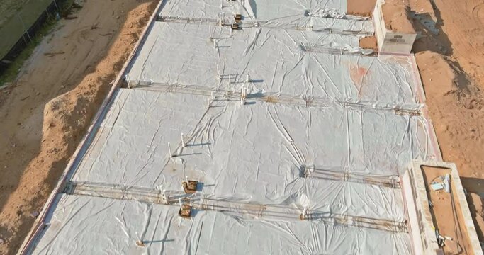 Laying in the a trench ground PVC pipes before pouring concrete
