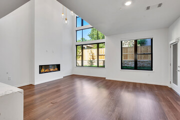 Living Room, Dining Room, and Kitchen in New Luxury Home with Open Concept Floor Plan and fireplace
