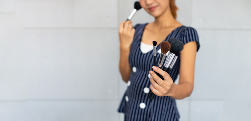 portrait of make up artist asian woman with makeup brushes.