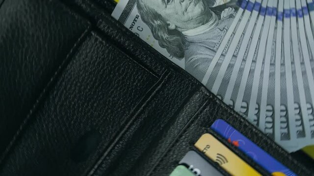 Banknote dollar put it in wallet, fly up purse. The 100 dollar spin rotate twist quickly fast fly, dispart, splash to the sides with centrifugal coriolis force. Green chroma key background.