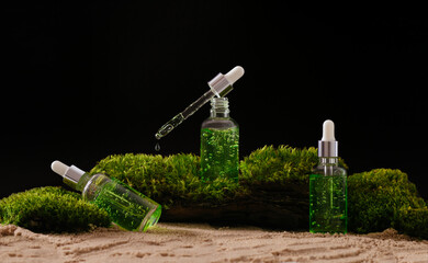 bottle of cosmetic serum on natural background with moss organic cosmetics	
