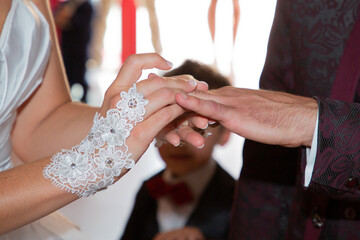 Obraz na płótnie Canvas bride and groom in marriage celebration exchange of wedding rings