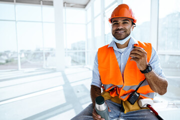 Portrait of a man worker in workwear on a break drink coffee and have rest