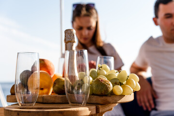 Fruit tray and bottle of champagne for romantic date on a yacht
