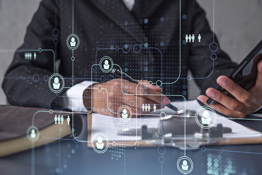 African American businesswoman signing the contract to boost her career and gain new opportunities in personal growth. Checking the detail of the deal at smartphone. Social media hologram icons - Powered by Adobe