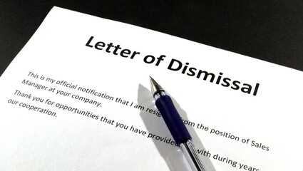 Obraz premium Filling out an application for dismissal from work. Text, pen for signing.