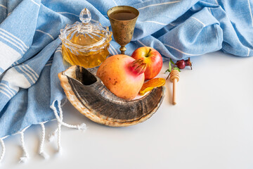 Shofar, honey, pomegranate, apple, goblet, cotton fabric on white background for Jewish holiday...