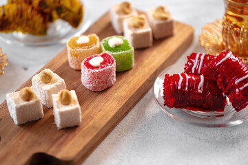 Various Turkish sweets and cup of tea on white textured background