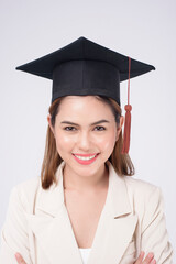 Portrait of young woman graduated over white background.
