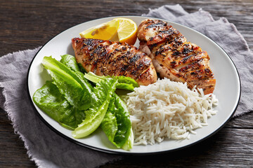 seared chicken breasts with lettuce and rice