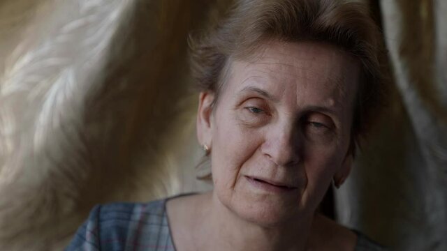old woman with teeth problem, looking at camera and smiling toothless smile, aged lady