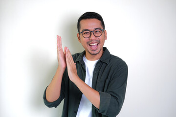 Adult Asian man clapping with happy expression to give appreciation