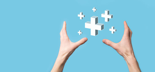 Hand hold 3D plus icon, man hold in hand offer positive thing such as profit, benefits, development, CSR represented by plus sign.The hand shows the plus sign