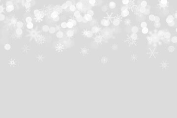 snowflakes on a light gray background with bokeh and place for text. Christmas and New Year pattern. Backdrop  for postcards