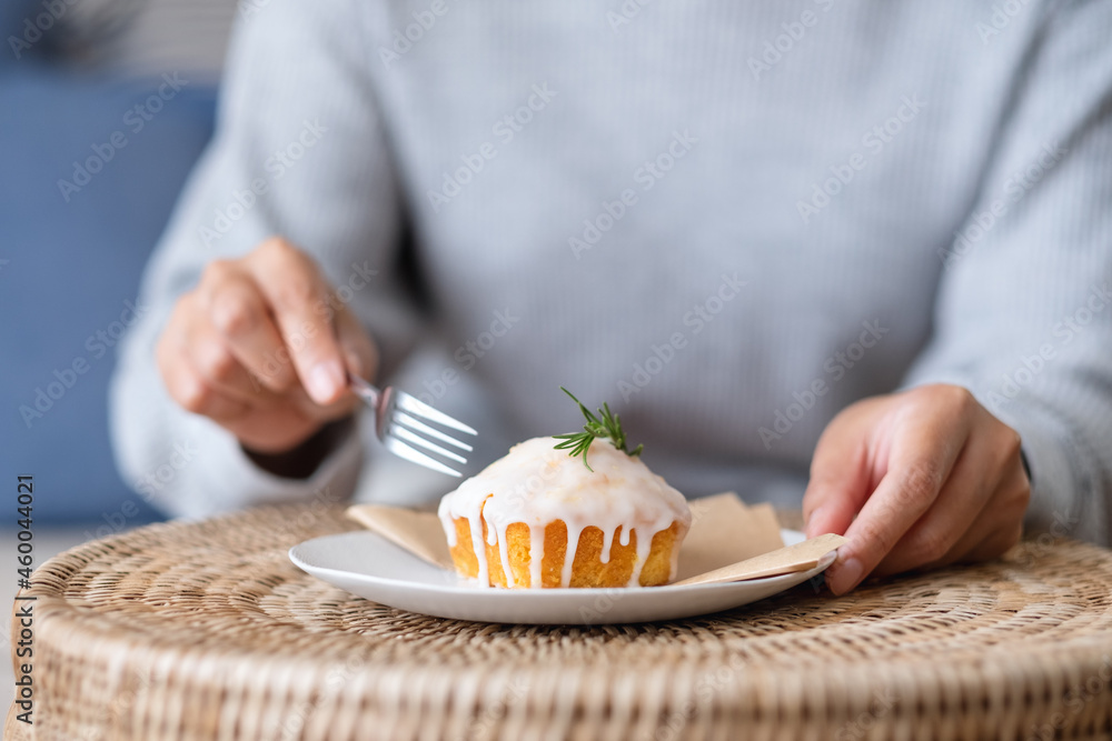 Wall mural A woman eating a piece of lemon pound cake