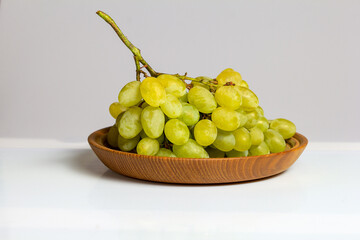 Fruits-grapes, peach, dogwood berries on a milky white background and gray background, close-up.