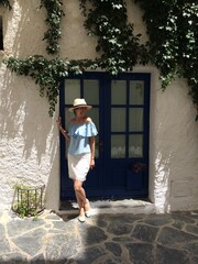 Naklejka premium Young female tourist standing near the door traveling in Spain