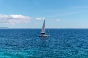 Small sailboat at sea on a sunny day 