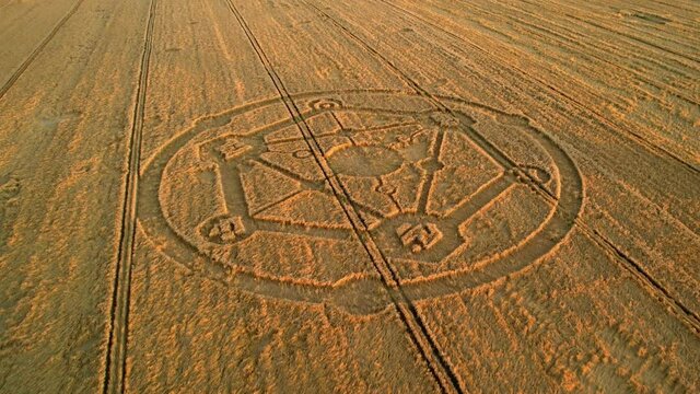 Fortnite molecular atom crop circle design sunset harvest meadow aerial drone view in Wiltshire push in to Birdseye