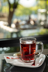Tea served in a glass with blurred background
