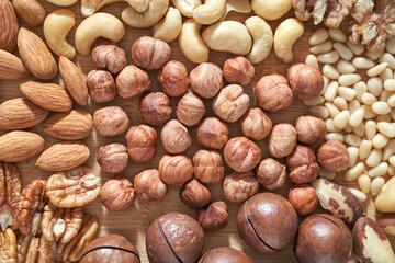 Many different nuts. Assortment healthy snacks. Mediterranean diet. Dry vegan charcuterie. Variety party pile. Kitchen table. Fat nutrients