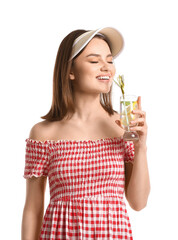 Beautiful young woman drinking fresh lemonade on white background