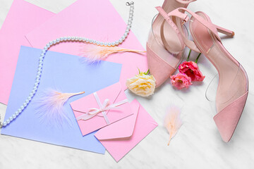 Cards with envelopes, roses and shoes on white background