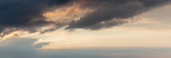 Obraz premium Dramatic sky with dark clouds at sunset