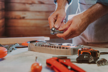 Close up of worker changing the nozzle for wrench