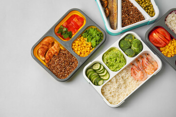 Containers with different healthy food on light background