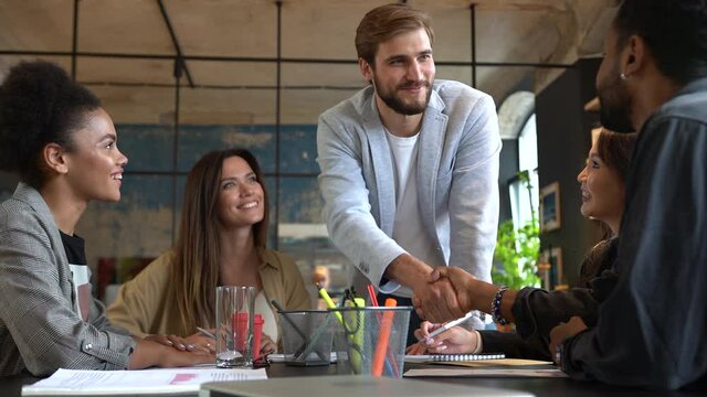 Business people shaking hands. Business, startup and people concept - happy multiracial creative team at the office.