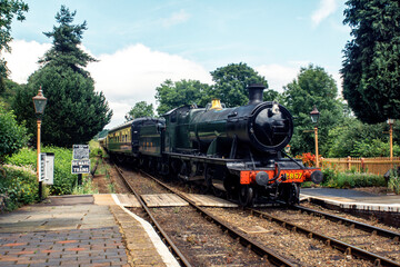 Fototapeta na wymiar GWR 2-8-0 Churchward 2800 Class locomotive pulling a rake of carriages