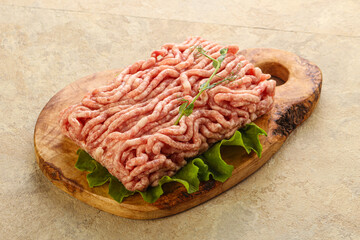 Raw minced pork meat over board