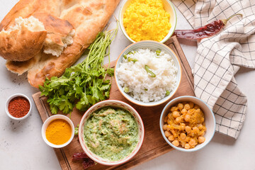 Traditional Indian food and spices on light background