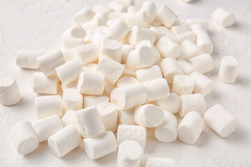 Fototapeta na wymiar Heap of tasty marshmallows on light background