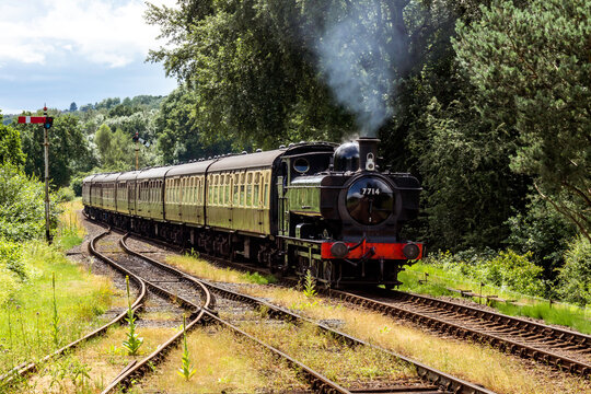 GWR Pannier tank locomotive hauling a rake of carriages