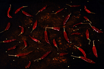 Pile crushed red pepper, Cayenne pepper, dried chili flakes isolated on black background