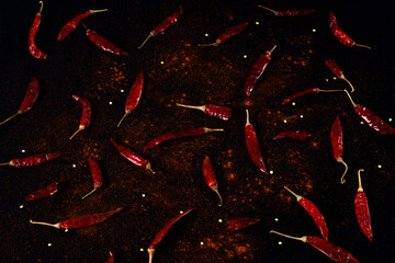 Pile crushed red pepper, Cayenne pepper, dried chili flakes isolated on black background
