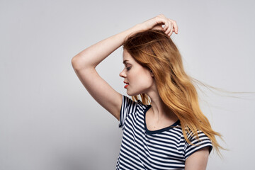 Fototapeta premium beautiful woman in a striped t-shirt gesture with his hands model studio