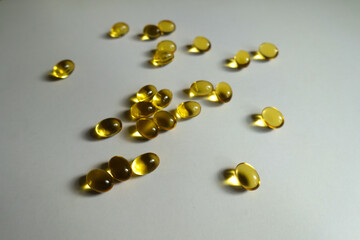 Many yellow softgel capsules of vitamin A (retinyl palmitate)